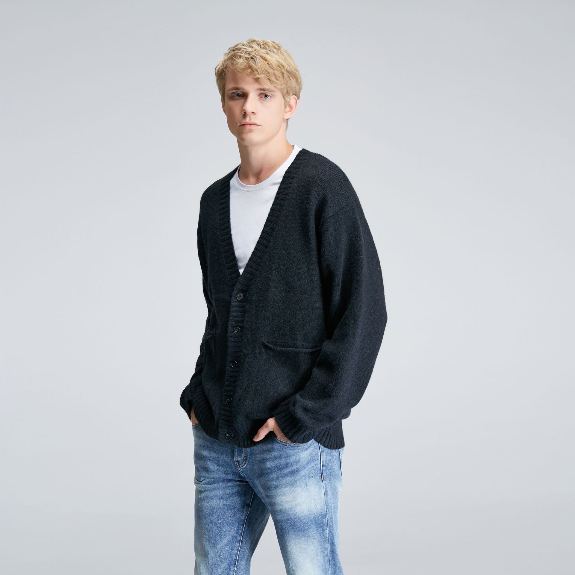 Men's black relaxed V-neck cardigan worn with jeans