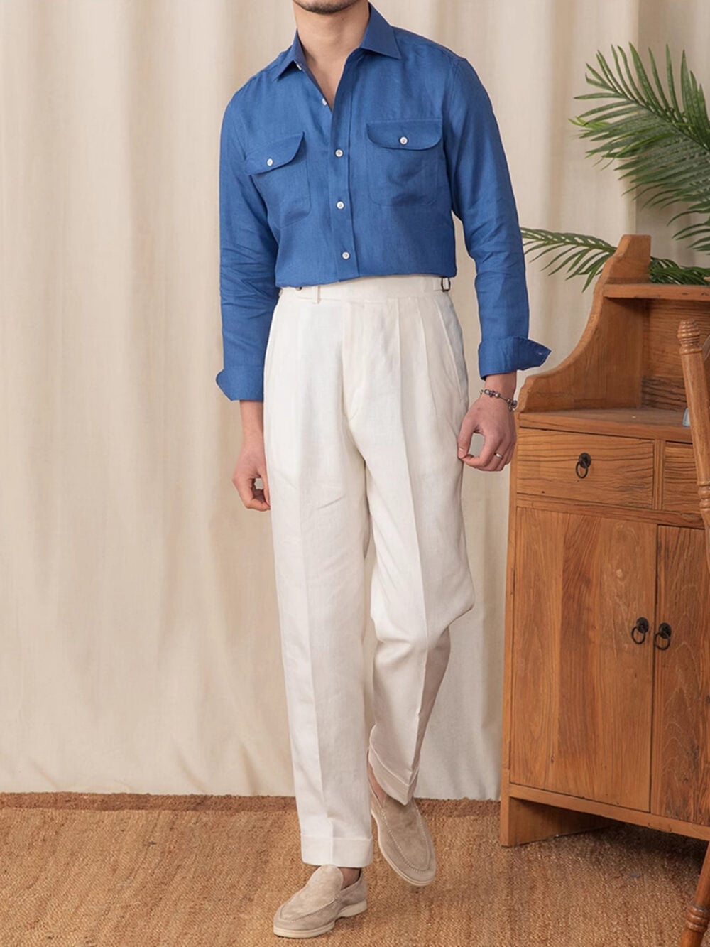 Blue linen shirt styled with white pleated trousers