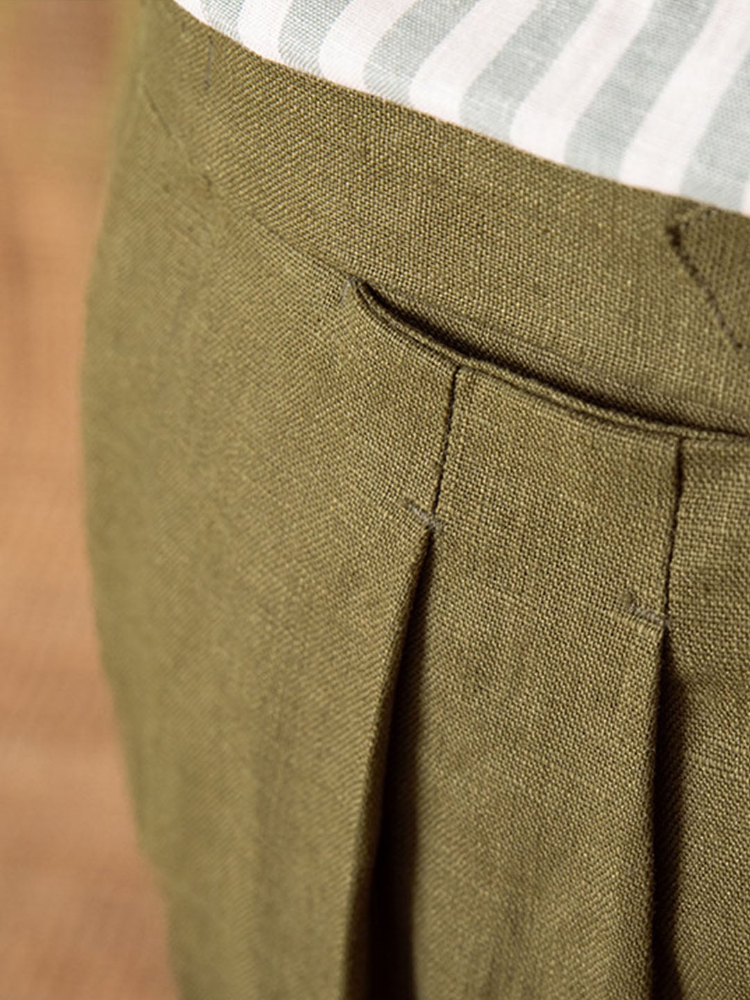 Men's white straight linen trousers styled with shirt and tie