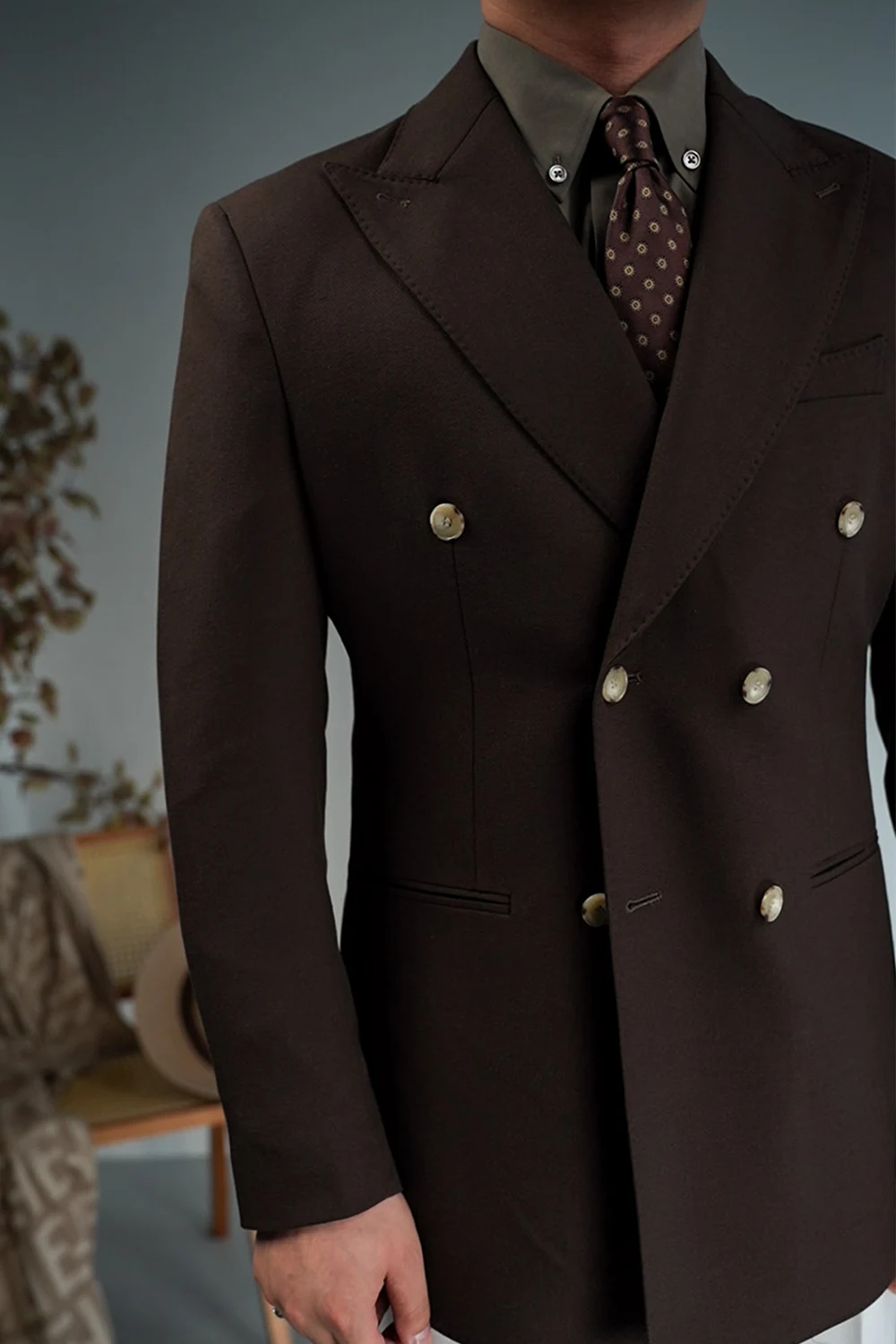 Close-up of coffee brown linen peak lapel blazer styled with shirt and tie
