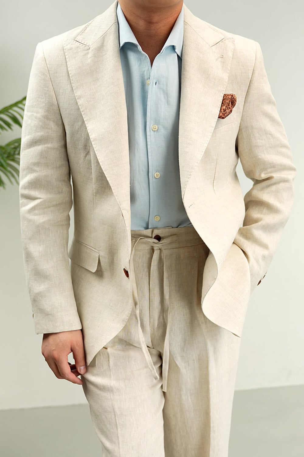 Natural beige linen peak lapel blazer styled with a blue shirt