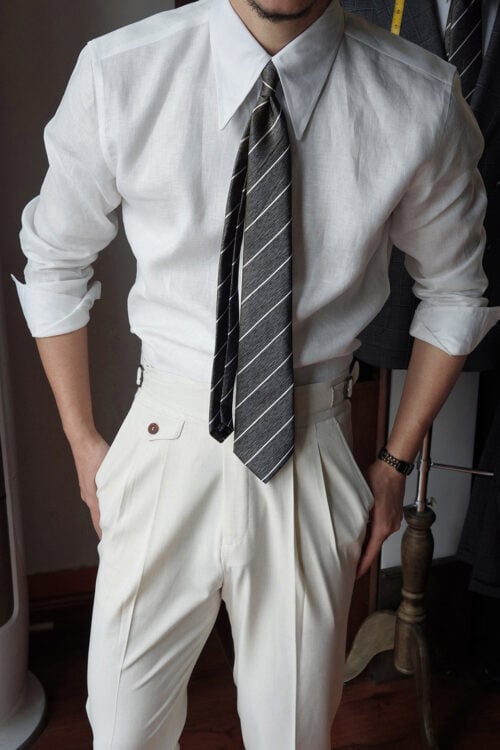 Men's white pure linen imperial collar shirt styled with a striped tie and pleated trousers