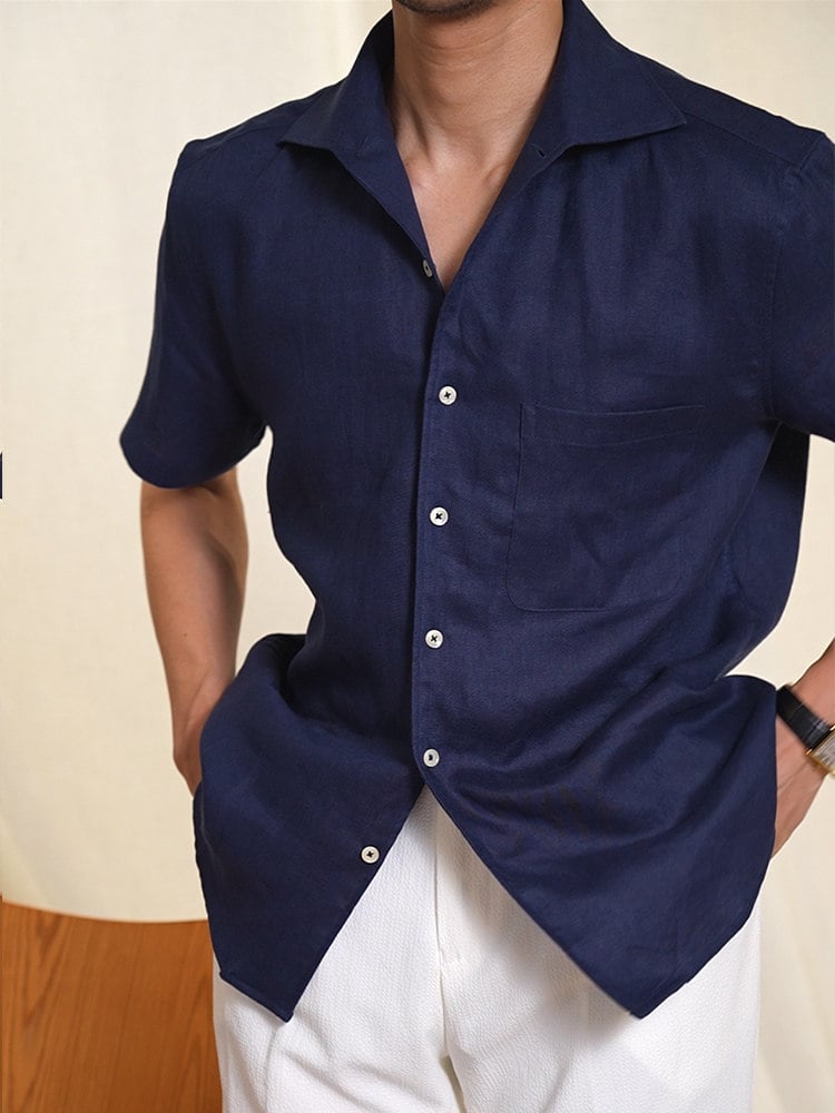 Front view of men's navy linen short sleeve shirt with one-piece collar and chest pocket